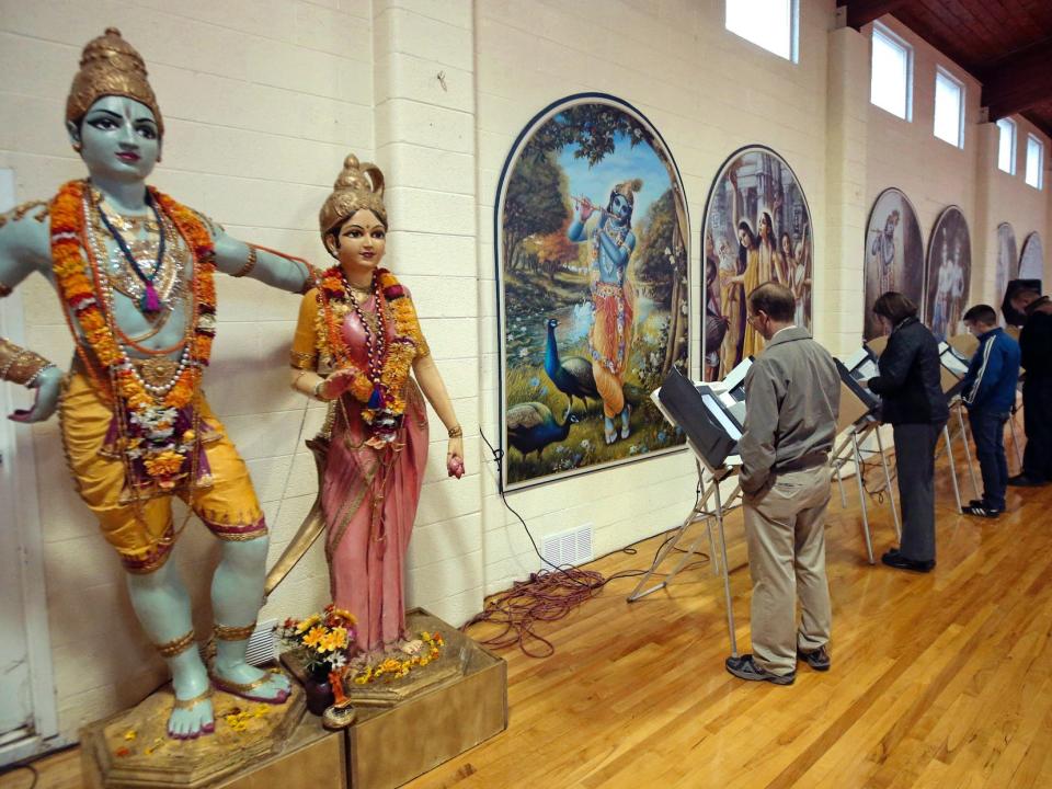 People vote at the polling place in Krishna Temple during election day in Salt Lake City, Utah.