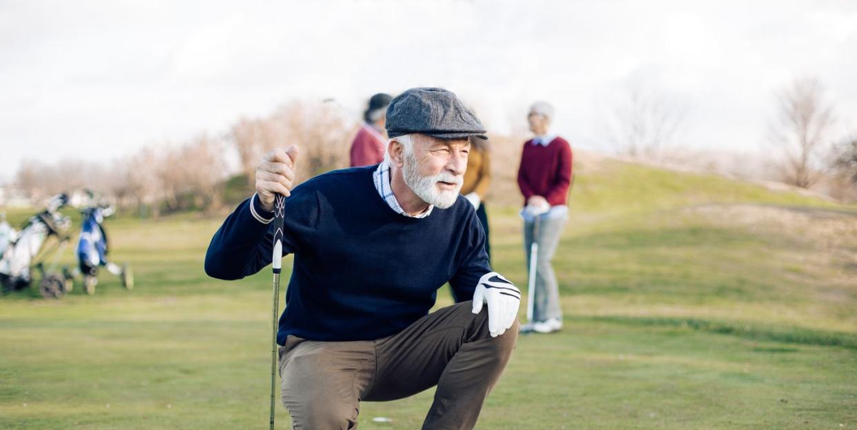 portrait of a senior golfer that took a shot