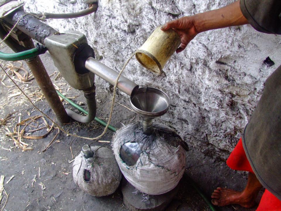 A man distills grogue at a small distillery on Santo Antão. <a href="https://www.gettyimages.com/detail/news-photo/man-distills-grogue-a-local-alcoholic-liquor-from-crushed-news-photo/872096820?adppopup=true" rel="nofollow noopener" target="_blank" data-ylk="slk:Jon G. Fuller/VW Pics/Universal Images Group via Getty Images;elm:context_link;itc:0;sec:content-canvas" class="link ">Jon G. Fuller/VW Pics/Universal Images Group via Getty Images</a>