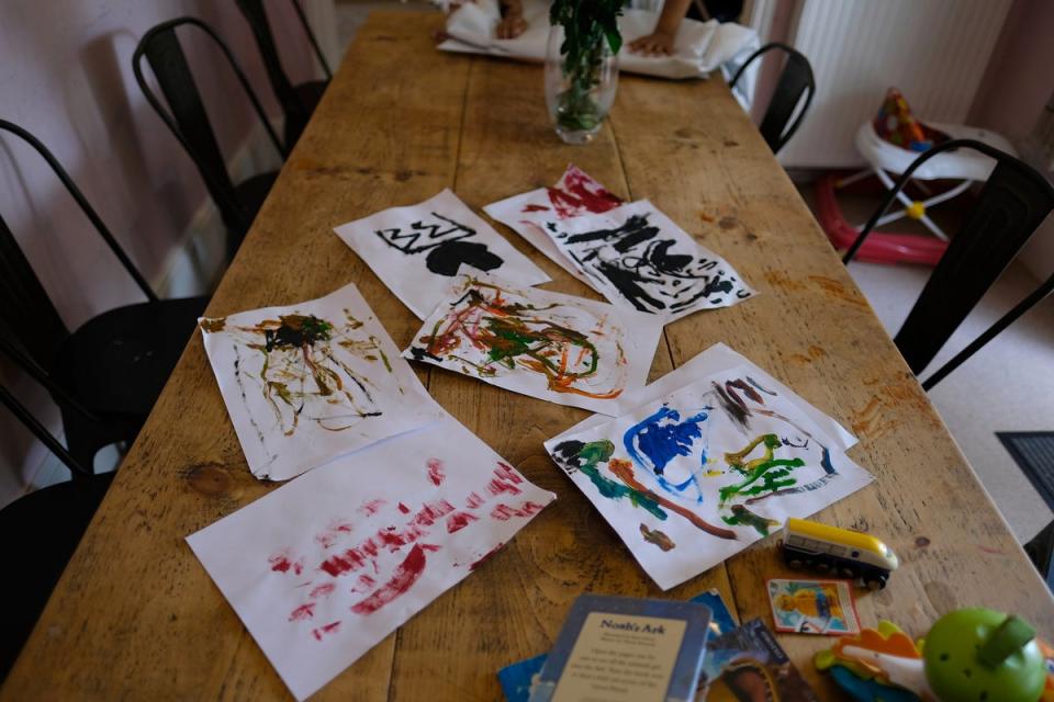 Children’s paintings lay on a table at the refuge (Emma Armstrong)