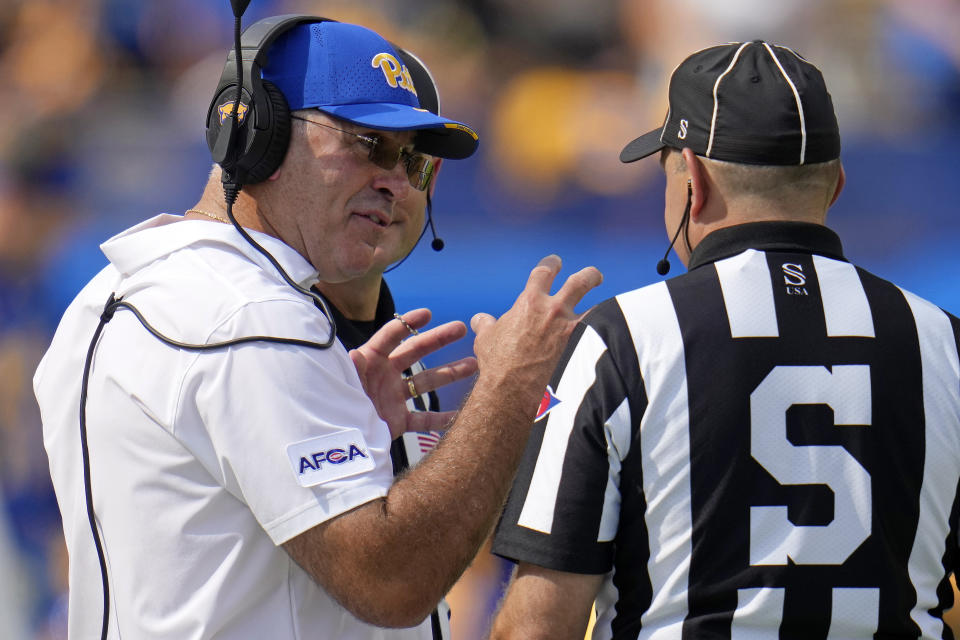 Pittsburgh head coach Pat Narduzzi, left, talks with officials during the first half of an NCAA college football game against Wofford in Pittsburgh Saturday, Sept. 2, 2023. (AP Photo/Gene J. Puskar)