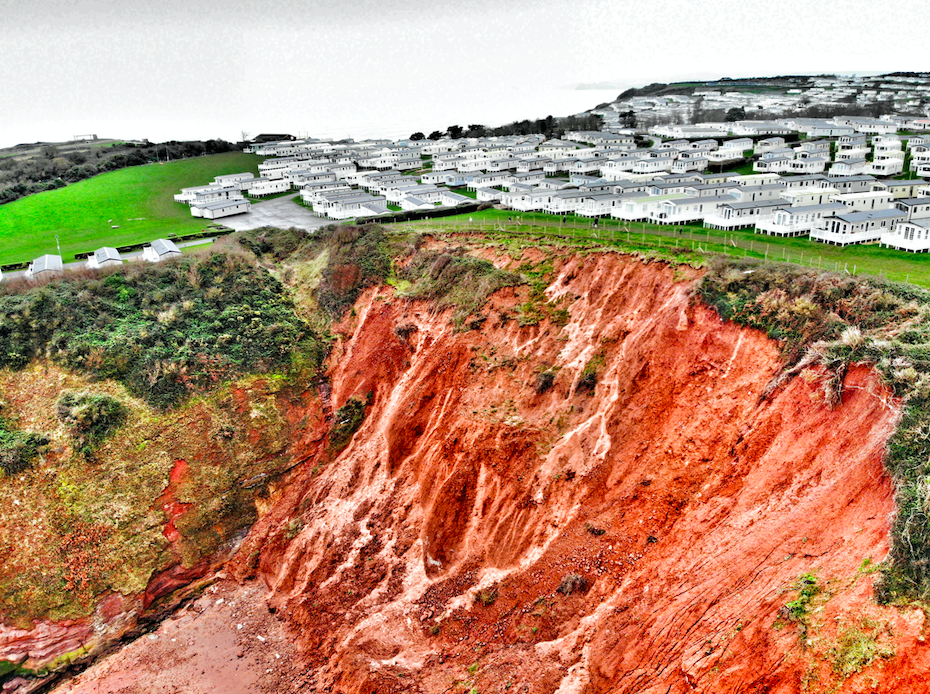 Drone images show the huge landslide next to the caravan park in Sandy Bay in Exmouth, Devon.