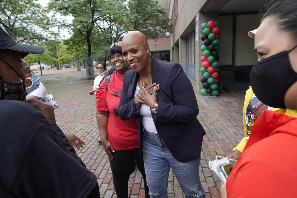 FILE - In this July 18, 2021 file photo, U.S. Rep. Ayanna Pressley, D-Mass., center, greets people before the start of the Roxbury Unity Parade, in Boston's Roxbury neighborhood. As workers return to the office, friends reunite and more church services shift from Zoom to in person, this exact question is befuddling growing numbers of people: to shake or not to shake. (AP Photo/Steven Senne, File)