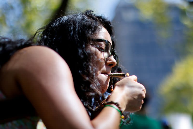 FILE PHOTO: An activist in favor of legalized marijuana lights a marijuana cigarette during a march as they wait for the Congress to pass a bill that would legalize it, in Mexico City