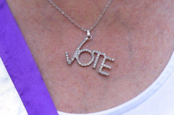 Kathy Chiron, President of the DC Chapter of the League of Women Voters, wears a necklace saying "vote"