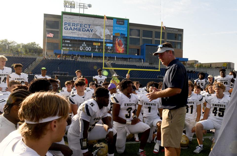 Hoban coach Tim Tyrrell talks to the Knights after a 45-6 win over Frederick Douglass at Tom Benson Hall of Fame Stadium on Saturday.