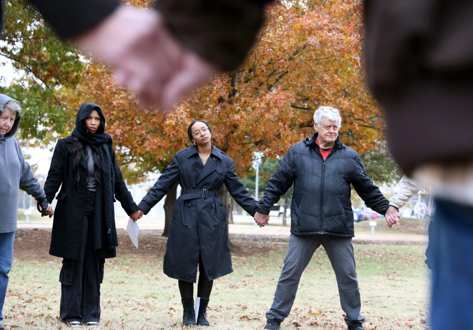 People gather in a prayer circle during a vigil against the death penalty on Thursday outside the Governor's Mansion.