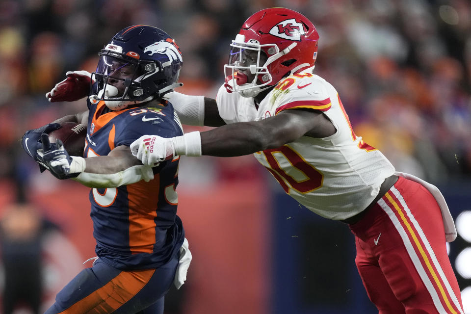 Denver Broncos running back Javonte Williams, left, runs against Kansas City Chiefs middle linebacker Willie Gay during the second half of an NFL football game Saturday, Jan. 8, 2022, in Denver. (AP Photo/David Zalubowski)