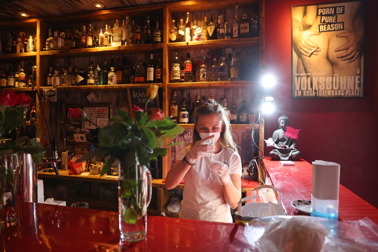 A medical assistant prepares syringes with doses of the Johnson and Johnson Janssen vaccine during a local vaccination drive at the Revolte Bar in Friedrichshain district on June 13, 2021, in Berlin, Germany. The bar owner, together with local doctors, organized the drive to administer 200 doses today, with invitations as a thank you gesture having gone out to people from the neighborhood who have supported the bar through the pandemic lockdown.