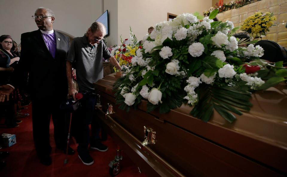 Antonio Basco places his hand on the casket of his wife Margie Reckard during her prayer service Friday, Aug. 16, 2019. at La Paz Faith Center in El Paso, Texas. She was one of the 22 people killed in the Walmart mass shooting on Aug. 3, 2019.