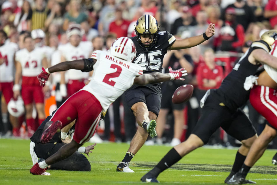 Purdue place kicker Julio Macias (45) kicks a field goal past Wisconsin cornerback Ricardo Hallman (2) during the first half of an NCAA college football game in West Lafayette, Ind., Friday, Sept. 22, 2023. (AP Photo/Michael Conroy)