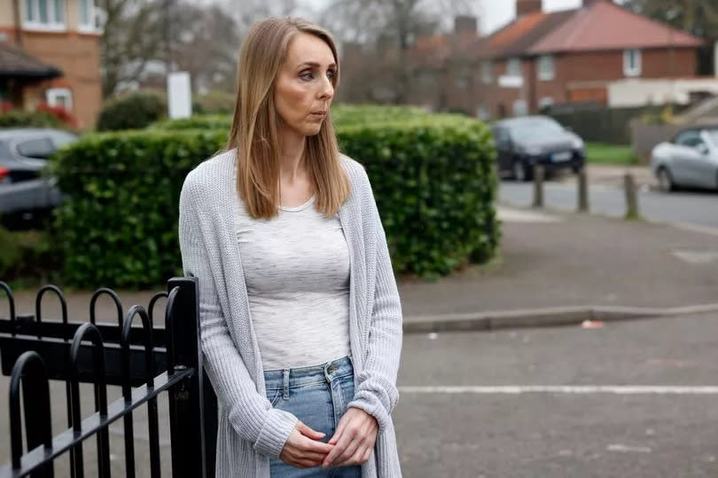 Laura Tuner stood outside her home in Morden leaning against a fence