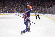 Edmonton Oilers' Connor McDavid (97) celebrates after his 50th goal of the season during second-period NHL hockey game action against the Boston Bruins in Edmonton, Alberta, Monday, Feb. 27, 2023. (Jason Franson/The Canadian Press via AP)