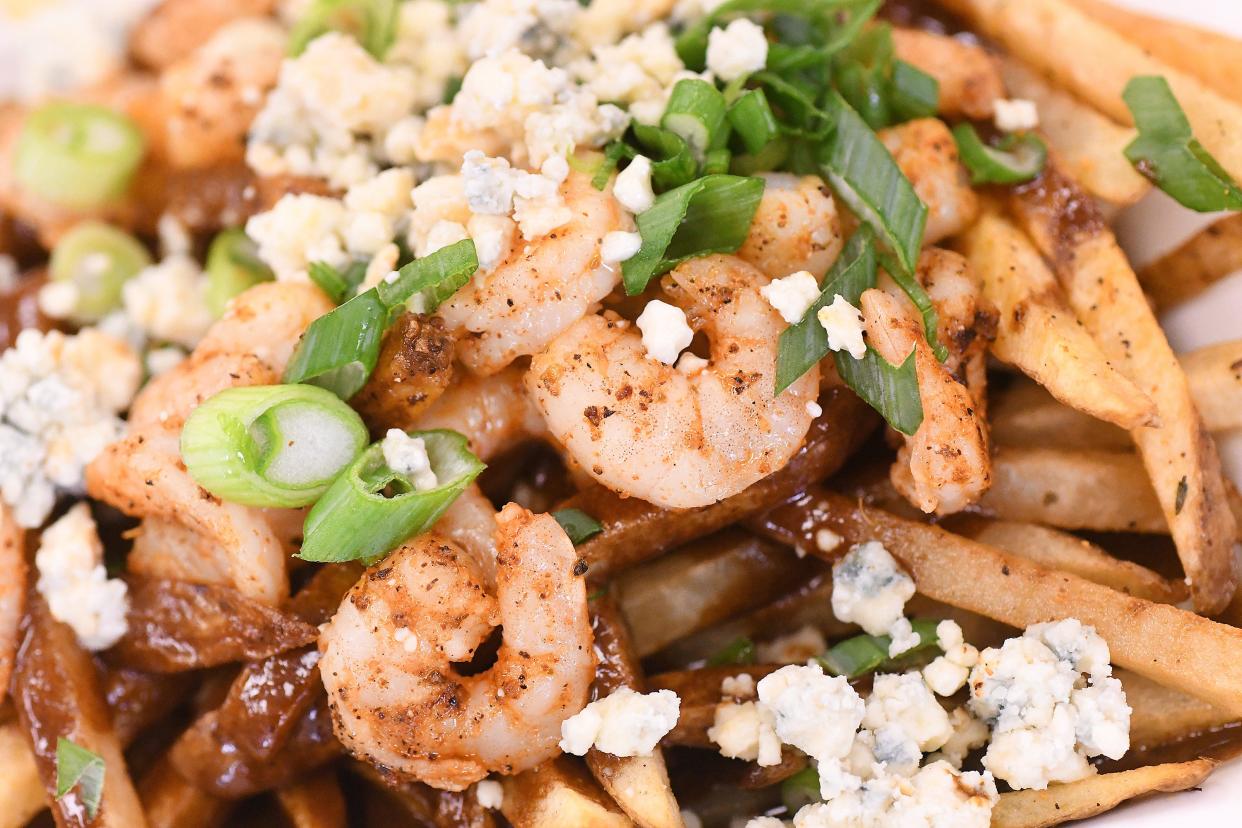 Poutine with Cajun barbecue shrimp gravy and smoked blue cheese at Pine Valley Market in Wilmington, N.C. STARNEWS FILE PHOTO