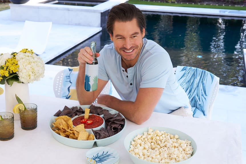 Craig Conover smiling in front of an outdoor table.