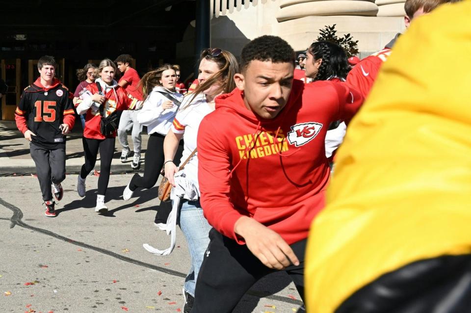 People flee after shots were fired near the Kansas City Chiefs' Super Bowl LVIII victory parade (AFP via Getty Images)