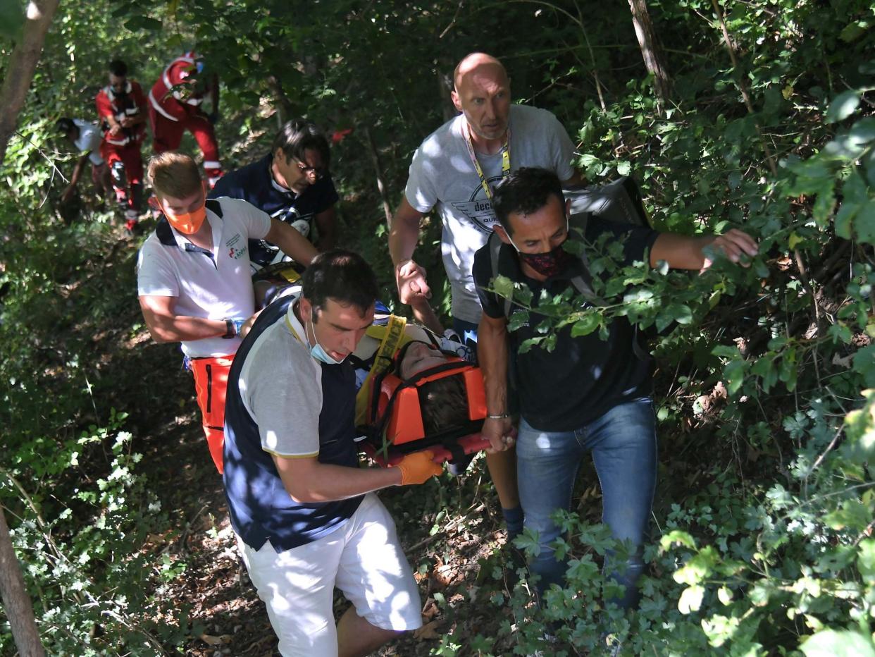 Remco Evenepoel is carried to an ambulance after crashing: Getty