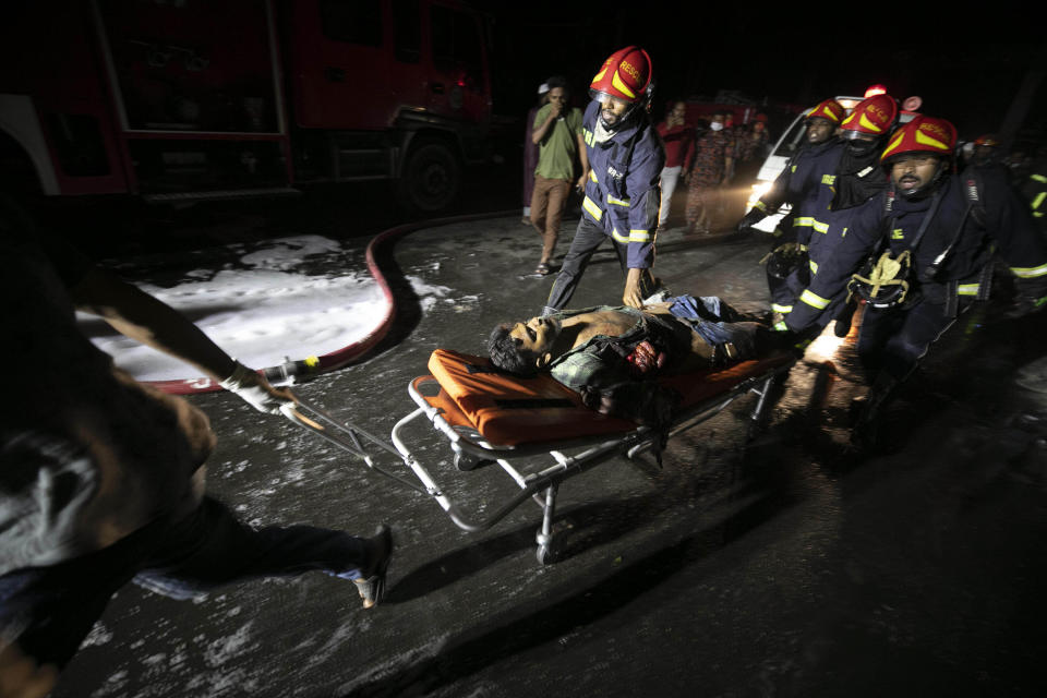 An injured man is rushed for treatment after a fire broke out at the BM Inland Container Depot, a Dutch-Bangladesh joint venture, in Chittagong, 216 kilometers (134 miles) southeast of capital, Dhaka, Bangladesh, early Sunday, June 5, 2022. Several people were killed and more than 100 others were injured in the fire the cause of which could not be immediately determined. (AP Photo)