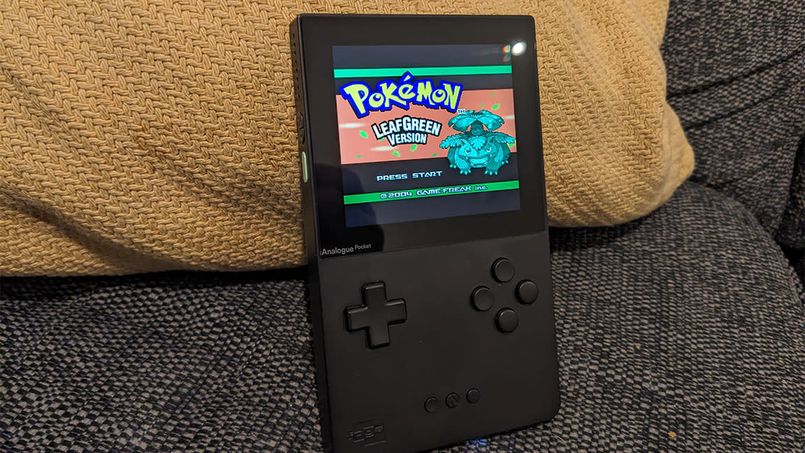  Analogue Pocket review; a small handheld on a sofa. 