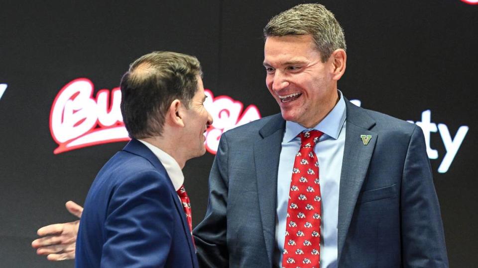 Garrett Klassy, right, is congratulated by Fresno State President Dr. Saul Jimenez-Sandoval after being announced as the university’s new athletic director during a news conference at Fresno State’s Josephine Theater on Friday, June 28, 2024.