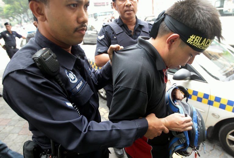 A police drags away a protester during a flash-mob protest in Kuala Lumpur on June 15, 2013. Those detained, who included opposition-aligned activists but also a 10-year-old boy, were held for disrupting public order in a busy shopping area of the capital Kuala Lumpur, media reports and opposition politicians said