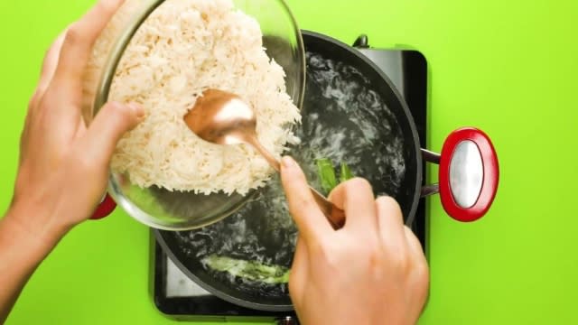 Pouring basmati rice into boiling water