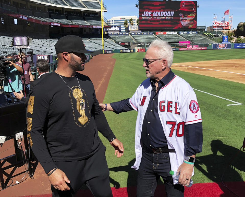 Los Angeles Angels first baseman Albert Pujols, left, speaks with new manager Joe Maddon after a baseball news conference at Angel Stadium in Anaheim, Calif., Thursday, Oct. 24, 2019. Maddon is returning to the Angels, where he worked as a coach before successful managerial stunts with baseball clubs in Tampa Bay and Chicago. (AP Photo/Greg Beacham)