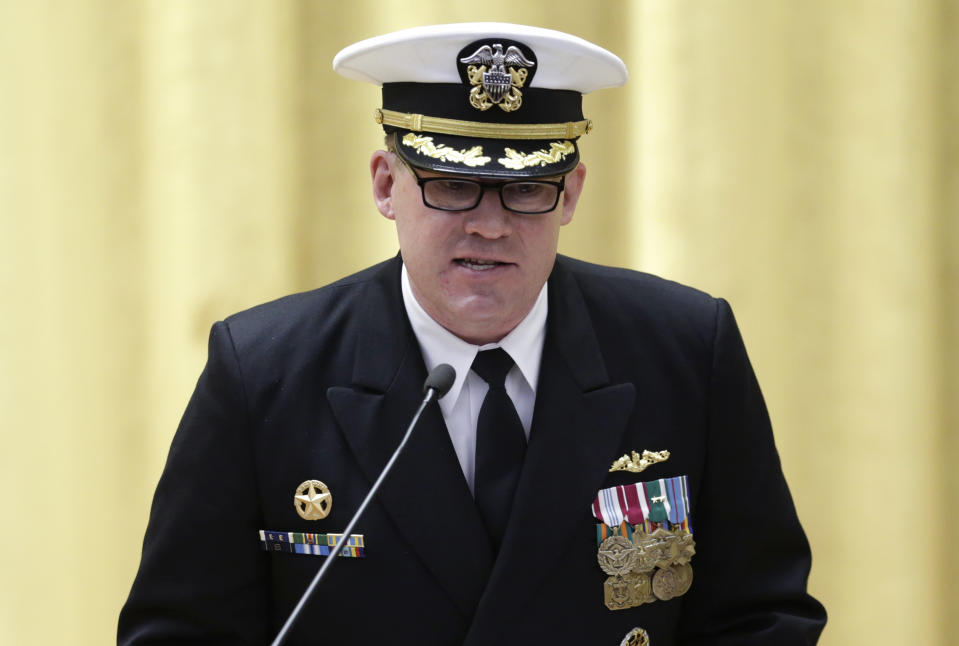 Commander Rolf Spelker speaks at the decommissioning ceremony for the fire-damaged USS Miami nuclear submarine at the Portsmouth Naval Shipyard, Friday, March 28, 2014, in Kittery, Maine. Rear Adm. Ken Perry, commander of the submarine Group Two in Groton, Conn., where the sub was based, acknowledged the seriousness of the event, but told the crowd they were there to celebrate the submarine and its crew’s achievements. “This is a tribute. This is a celebration of the ship’s performance and the superb contributions to the nation’s defense and this is how we’re going to treat it. So I expect to see some smiles out there,” he said. (AP Photo/Robert F. Bukaty)