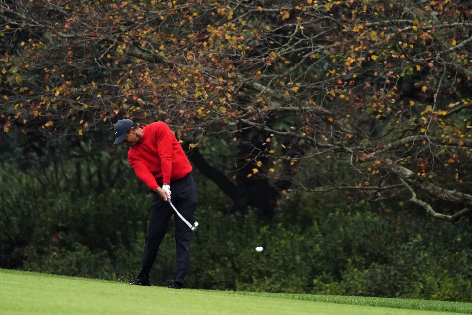 FILE - Tiger Woods hits on the second fairway during the final round of the Masters golf tournament in Augusta, Ga., in this Sunday, Nov. 15, 2020, file photo. Gone are the autumn hues of gold, orange and red in the trees, the brown leaves mixed in with the pine straw on the ground. Augusta National is blazing with pink and red and purple azaleas, accented by the white blooms of dogwood. Postponed last year because of the COVID-19 pandemic, the Masters is back to being that annual rite of spring. (AP Photo/Matt Slocum, File)