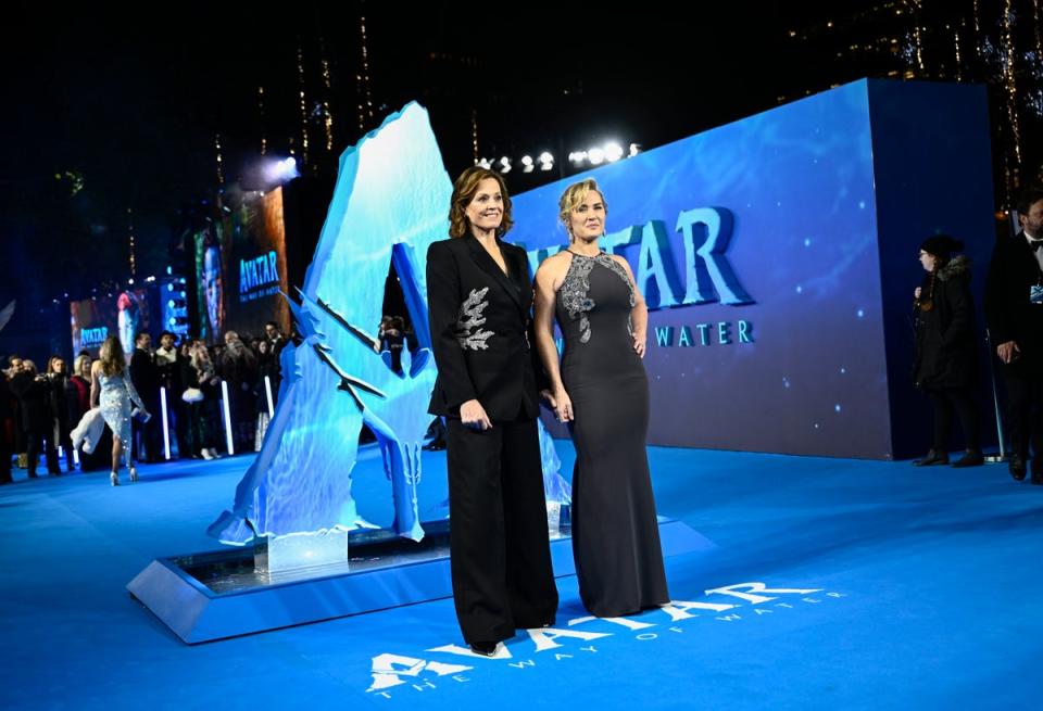 Winslet with co-star Sigourney Weaver in their matching embroidery (Gareth Cattermole/Getty Images f)