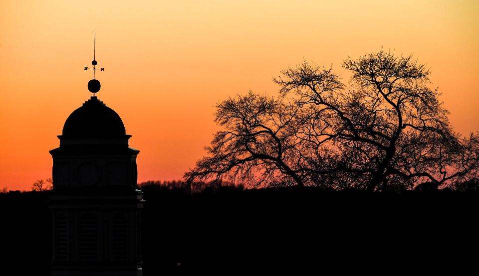 The sun set with an orange sky with First Presbyterian Church minutes before a dark sky with Jupiter and Saturn appearing close to each other December 21, 2020.  While the two planets appear close from earth perspective, astronomers say they are still millions of miles apart, and the two planets have not been this close in 800 years. 