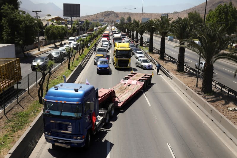 People block the road during a protest against the road tolls in the outskirts of Santiago