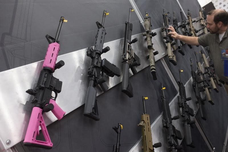 A pink assault rifle hangs among others at an exhibit booth at the George R. Brown convention center, the site for the National Rifle Association's (NRA) annual meeting in Houston, Texas May 5, 2013. REUTERS/Adrees Latif