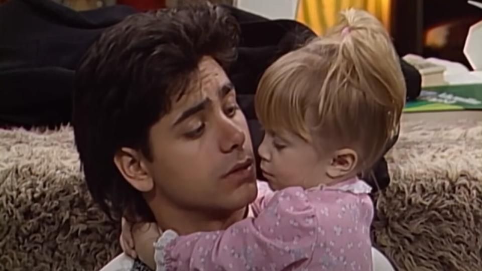 The Olsen twins, Mary-Kate Olsen or Ashley Olsen as Michelle and John Stamos as Jesse on Full House.