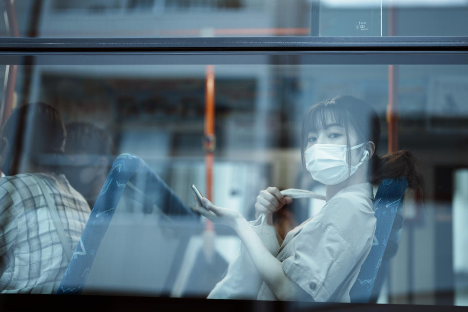 FILE - In this July 22, 2021, file photo, a woman sits on a bus ahead of the 2020 Tokyo Olympics in Mishima, Japan. (AP Photo/Thibault Camus, File)