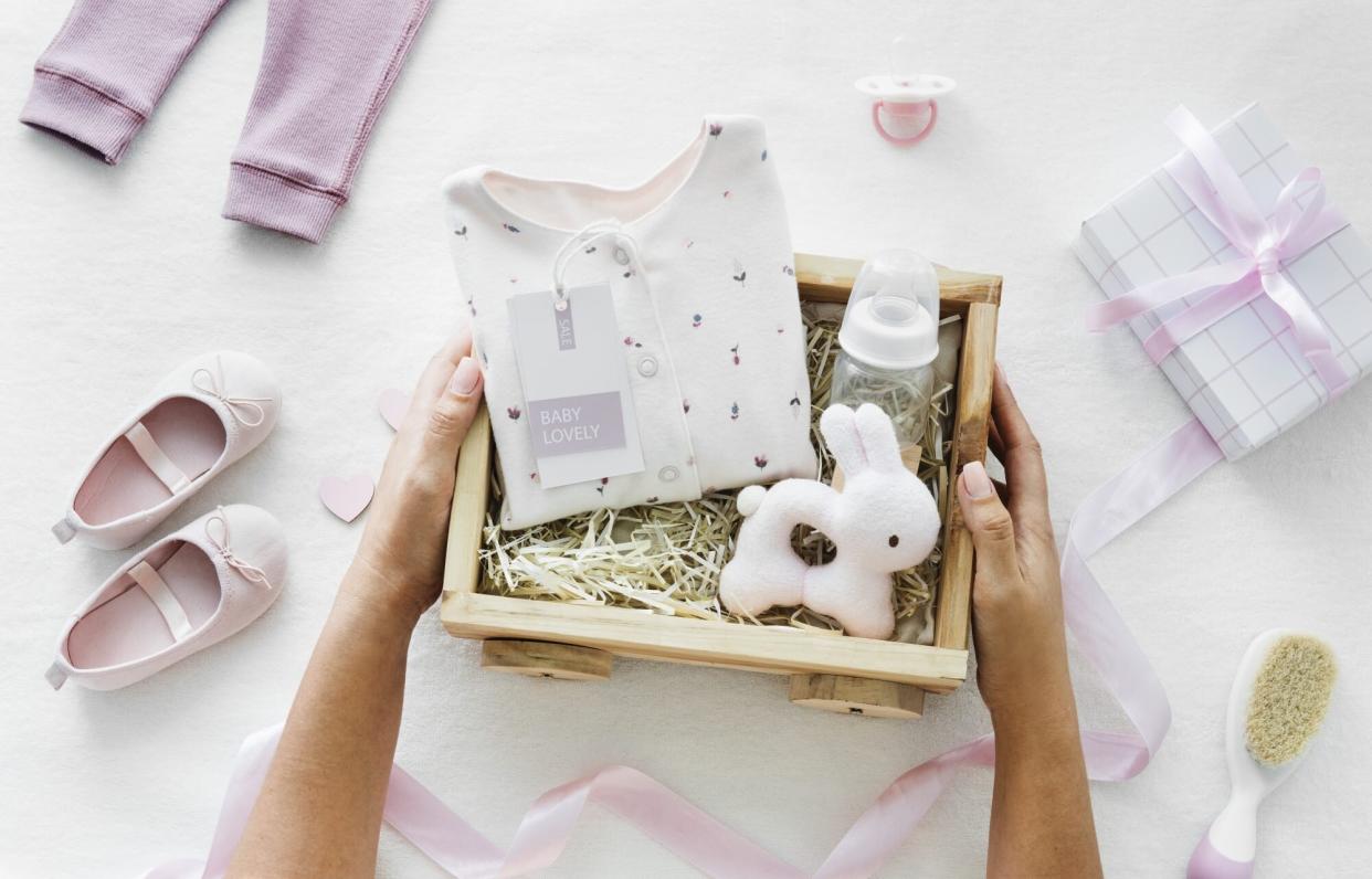 woman opening a box of baby shower gifts