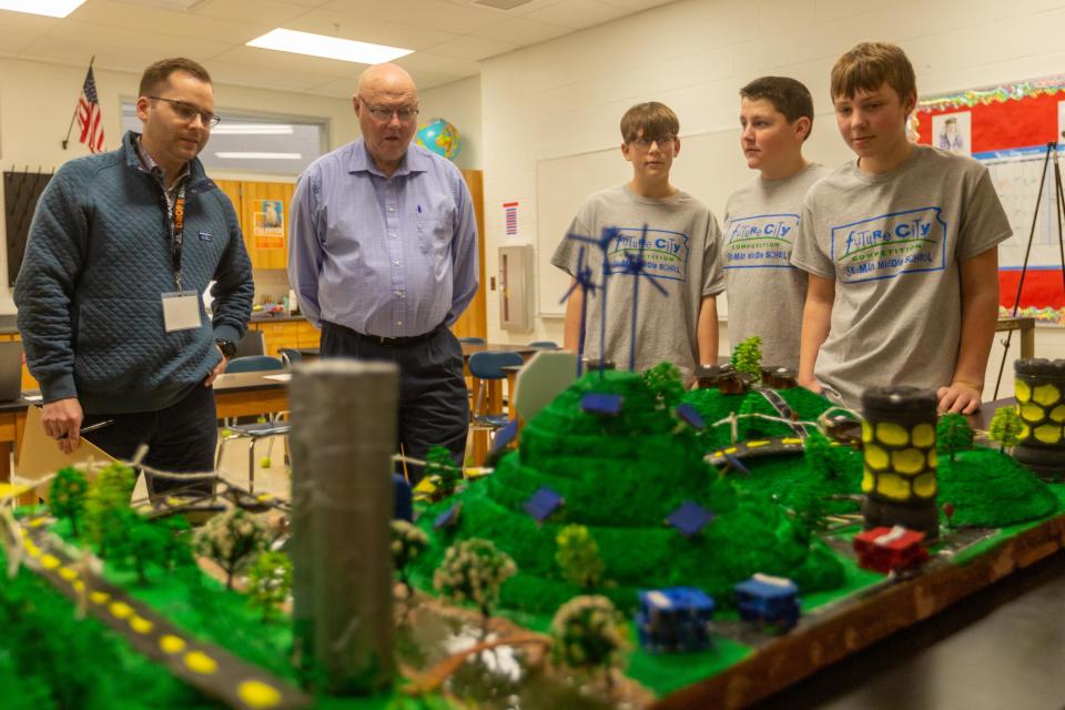 Seaman Middle School students Titus Tootle, Thomas Cain and Skylar Purvis present their model. Storm King City, as part of the Future City regional competition Saturday at the school.