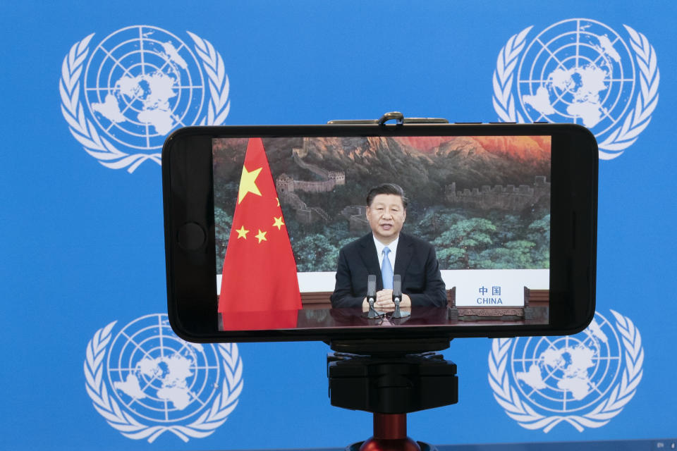 Chinese President Xi Jinping is seen on a phone screen remotely addressing the 75th session of the United Nations General Assembly, Tuesday, Sept. 22, 2020, at U.N. headquarters. This year's annual gathering of world leaders at U.N. headquarters will be almost entirely "virtual." Leaders have been asked to pre-record their speeches, which will be shown in the General Assembly chamber, where each of the 193 U.N. member nations are allowed to have one diplomat present. (AP Photo/Mary Altaffer)