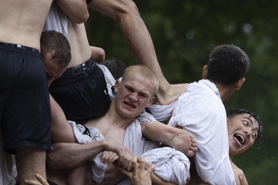 Class of 2027 plebes climb during the Herndon Monument Climb at the U.S. Naval Academy, Wednesday, May 15, 2024, in Annapolis, Md. Freshmen, known as Plebes, participate in the climb to celebrate finishing their first year at the academy. The climb was completed in two hours, nineteen minsters and eleven seconds to complete. (AP Photo/Tom Brenner)