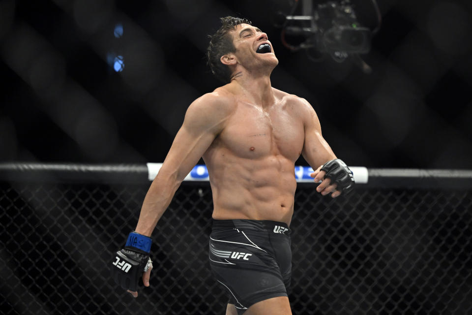 Actor Jake Gyllenhaal reacts after "knocking down" another actor while filming a scene for an upcoming remake of the 1989 movie "Road House" during a UFC 285 mixed martial arts event Saturday, March 4, 2023, in Las Vegas. (AP Photo/David Becker)