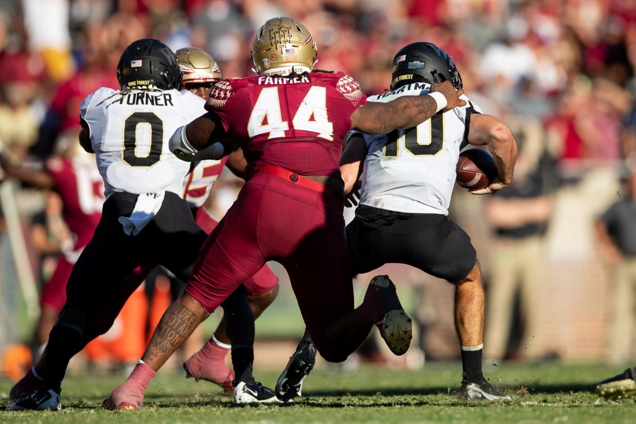 Florida State Seminoles defensive tackle Joshua Farmer (44) sacks Wake Forest Demon Deacons quarterback Sam Hartman (10).The Florida State Seminoles lost to the Wake Forest Demon Deacons 31-21 Saturday, Oct. 1, 2022.