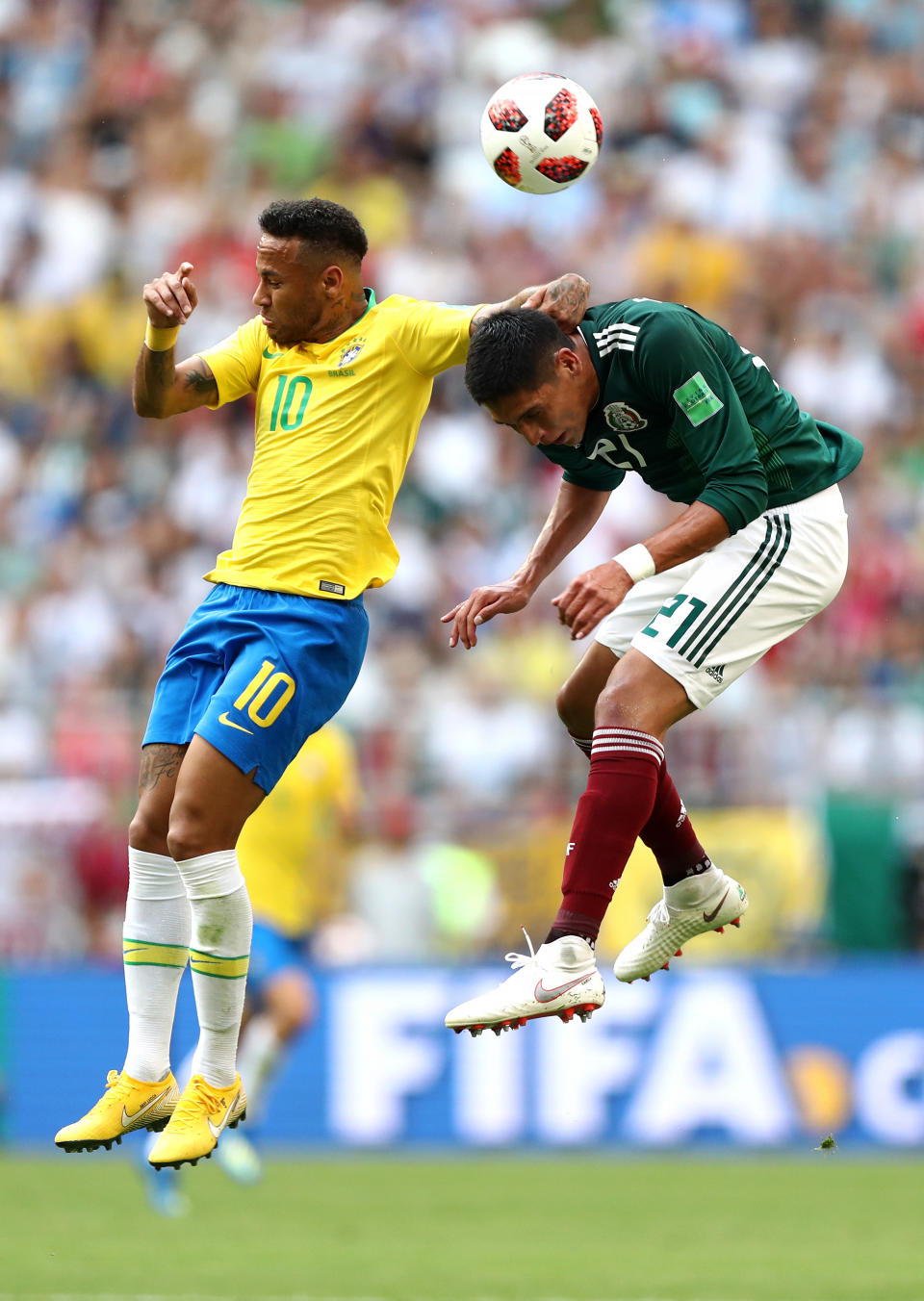 <p>Neymar Jr wins a header over Edson Alvarez of Mexico during the 2018 FIFA World Cup Russia Round of 16 match between Brazil and Mexico at Samara Arena on July 2, 2018 in Samara, Russia. (Photo by Ryan Pierse/Getty Images) </p>