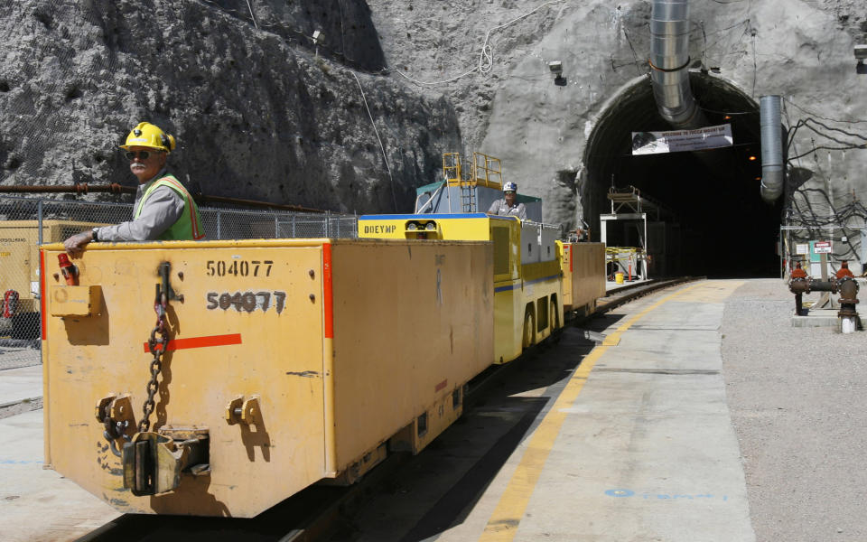 FILE - In this April 13, 2006, file photo, Pete Vavricka conducts an underground train from the entrance of Yucca Mountain in Nevada. Nevada is asking the federal Nuclear Regulatory Commission to restart its look at licensing the mothballed Yucca Mountain national radioactive waste repository, with the expectation that will finally end four decades of debate and kill it.( AP Photo/Isaac Brekken, File)