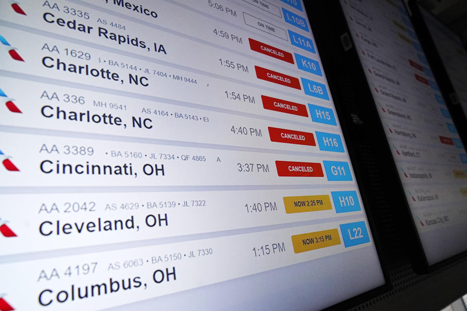 American Airlines flight information screens display flight information, including canceled and delayed flights, at O'Hare International Airport in Chicago, Thursday, Dec. 22, 2022. (AP Photo/Nam Y. Huh)