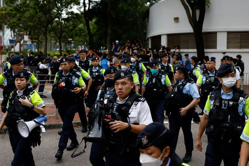 Police stand guard outside the West Kowloon Magistrates' Courts building during the verdict of the 47 pro-democracy activists charged under the national security law, in Hong Kong