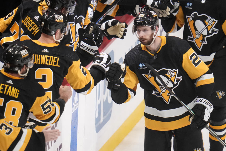 Pittsburgh Penguins' Marcus Pettersson (28) returns to the bench after scoring during the first period of an NHL hockey game against the New York Islanders in Pittsburgh, Tuesday, Feb. 20, 2024. (AP Photo/Gene J. Puskar)