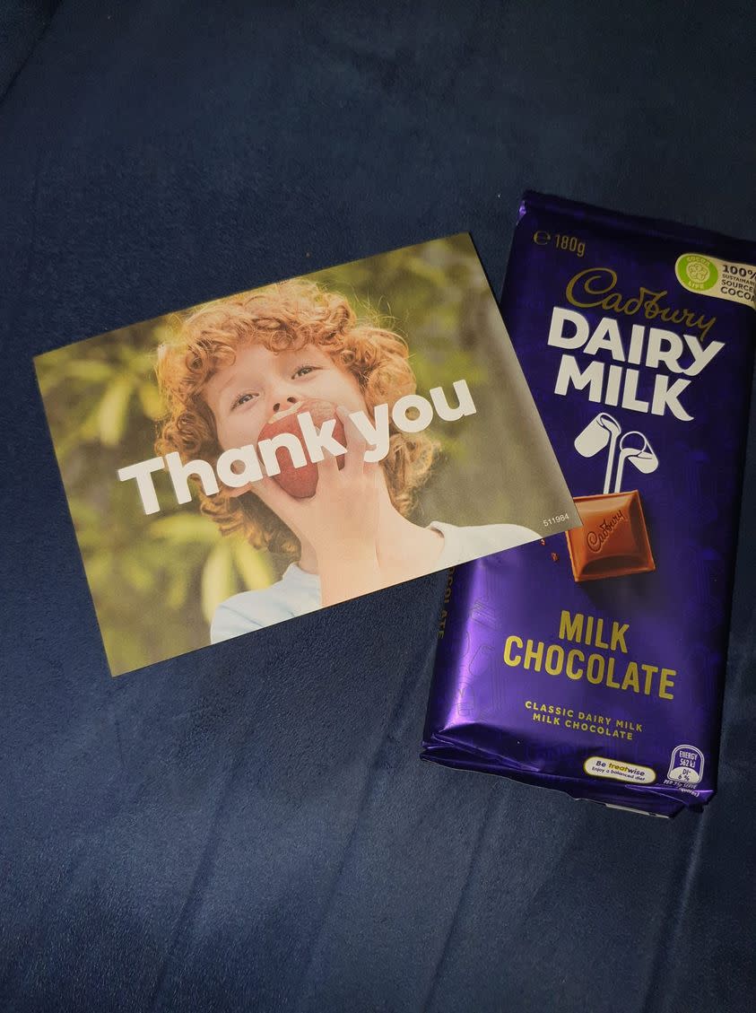 A photo of a Cadbury chocolate block and a Woolworths thank you card a shopper received. Source: Facebook