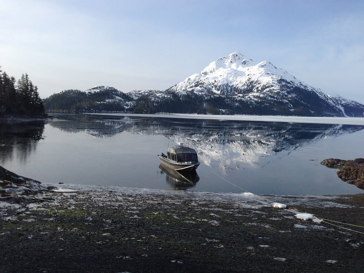 A fishing boat on the shore of Black Sand Beach in Alaska.