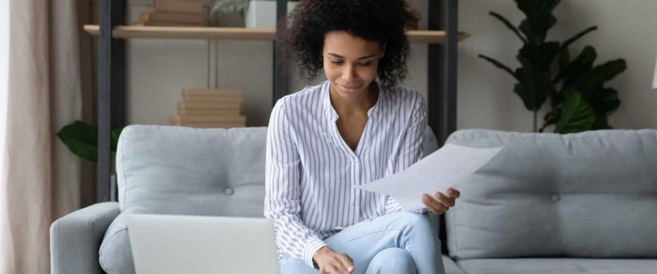 Smiling mixed race woman shops for a lower mortgage rate.