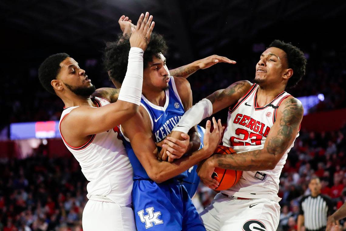 Kentucky forward Jacob Toppin, center, fights for control of the ball with Georgia center Braelen Bridges (23) during Saturday’s game at Stegeman Coliseum in Athens, Ga.